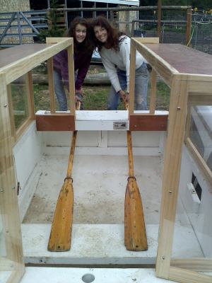 Standard wooden oars slip into transom holes from inside and rest on the seat or floor. Beautiful models are my wife (boat's namesake, 